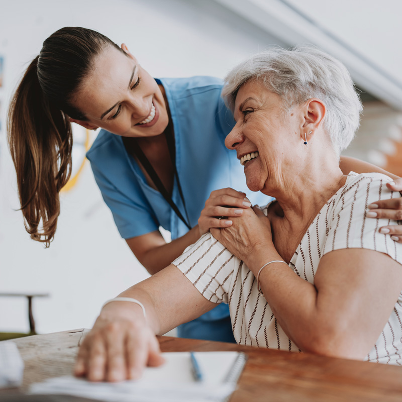 nurse and patient smiling at eachother