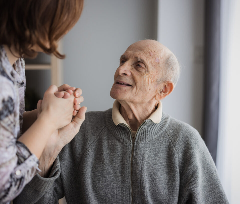 Elderly man looking at caregiver